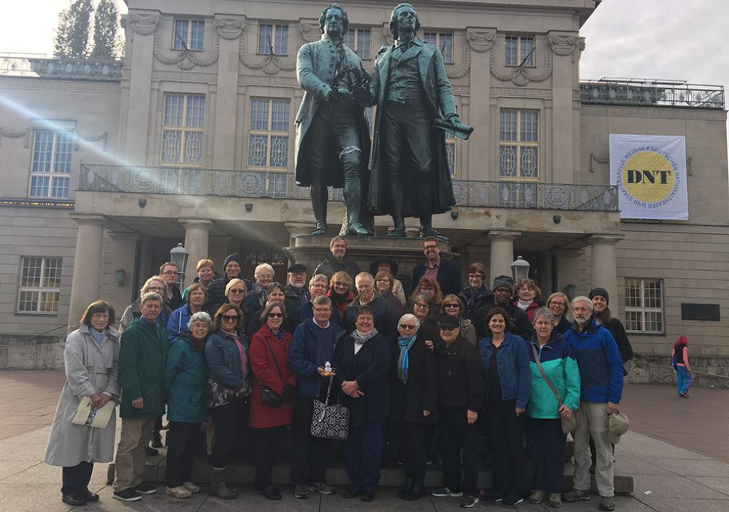 Germany trip participants in front of statue